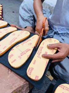 Hand-cutting the leather insole