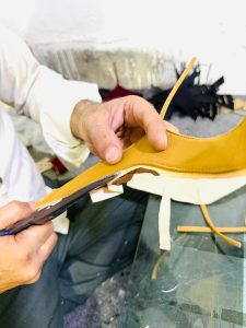 Hand-stitching the shoe upper